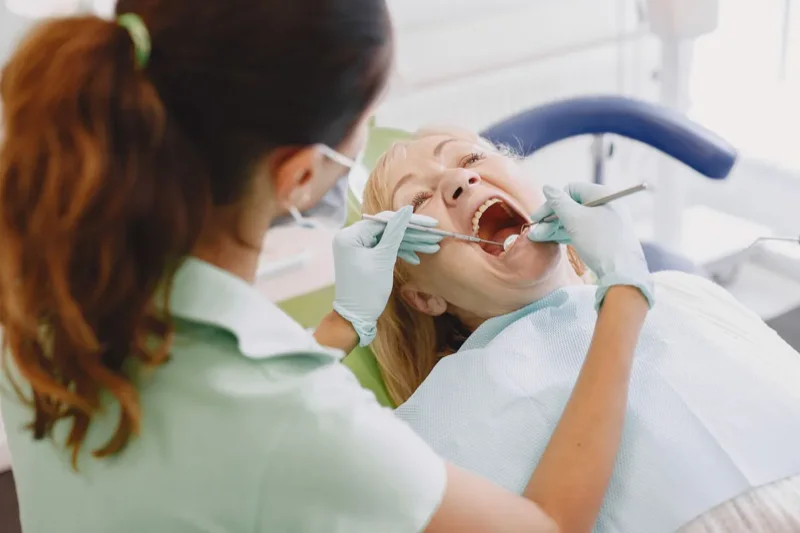 Dentist examining a patient in a cosmetic dentistry clinic