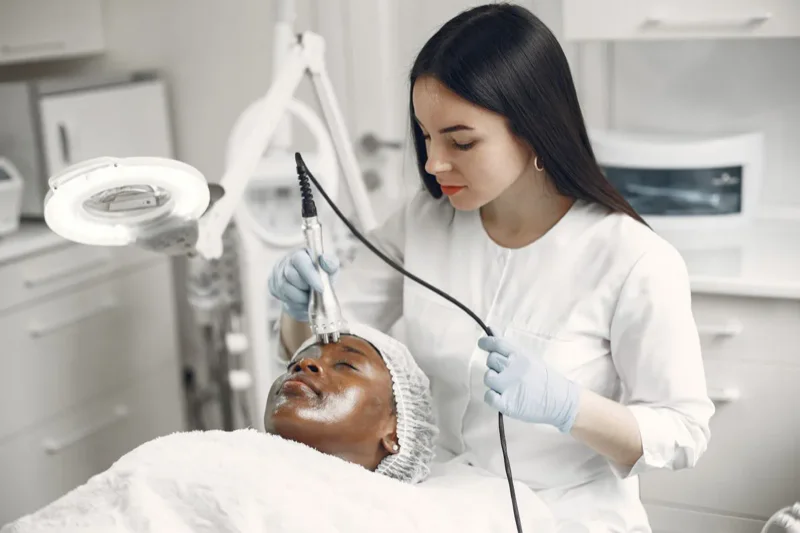 Dermatologist treating a patient in a modern medical aesthetics clinic